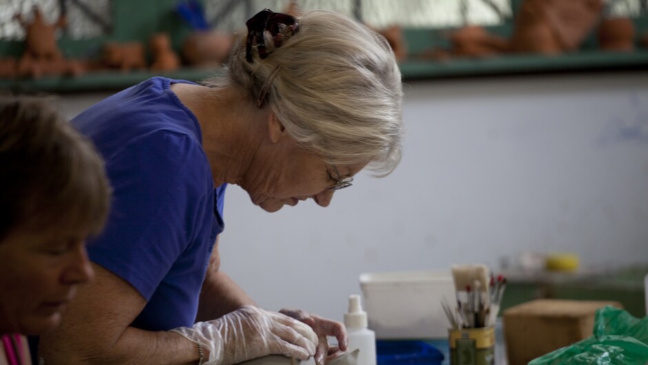 Ceramic artists working in the communal pottery room at the Quarry Arts Centre