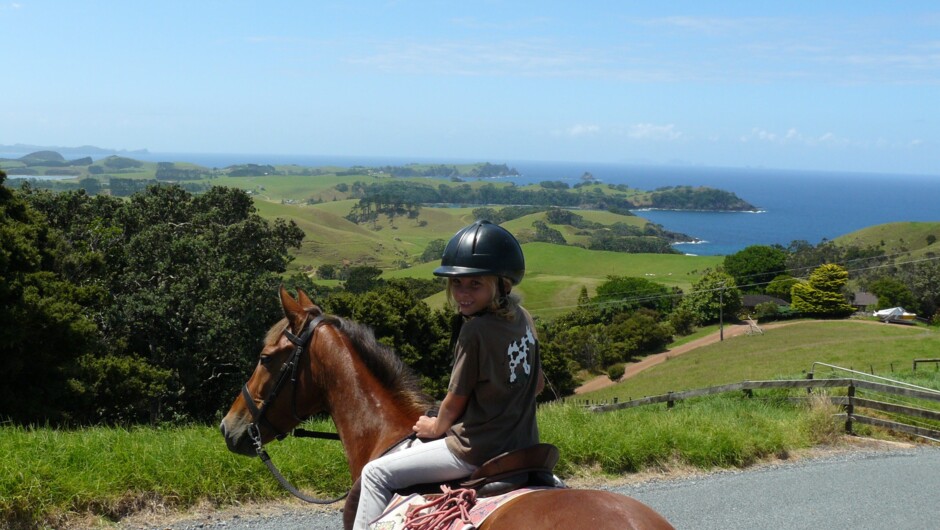 Lovely views and a smily happy young rider.