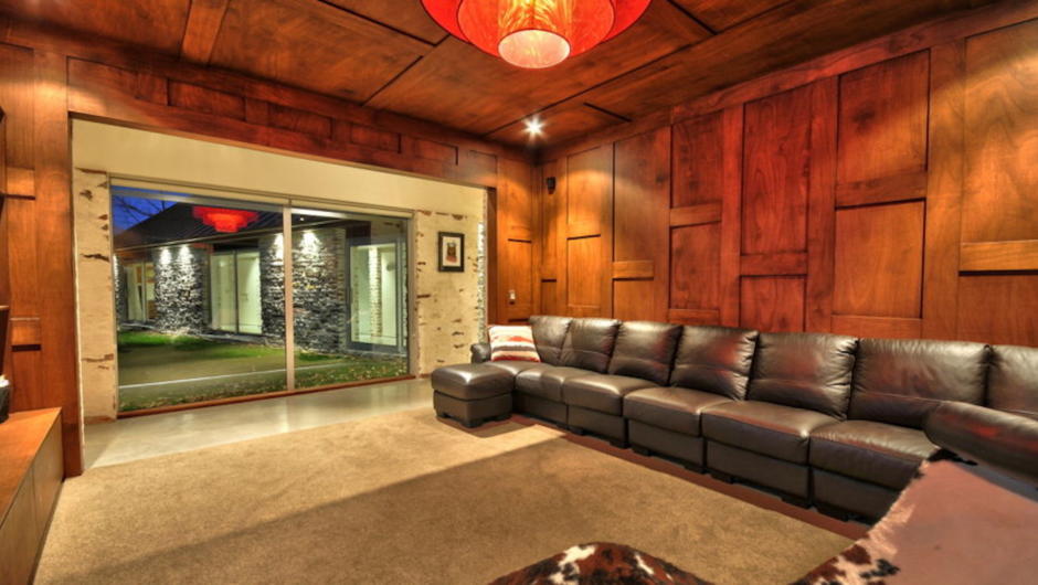 A very cool TV and media room with long leather couch