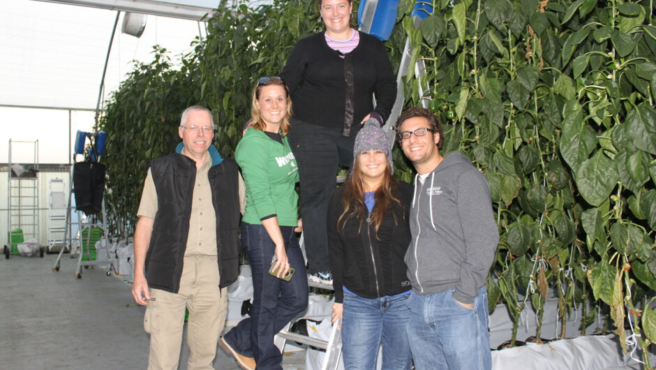 A happy farm tour group in the greenhouse.
