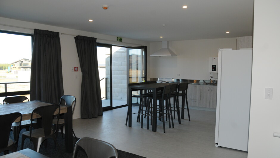View of communal fully equipped Kitchen from dining room