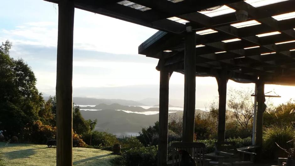 Watch the sunrise over the hills from the deck at Haurata High Country Retreat
