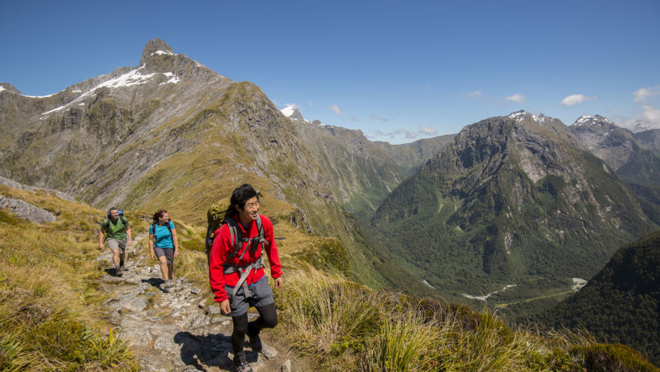 Guide and walkers on the Mackinnon Pass, Milford Track, New Zealand