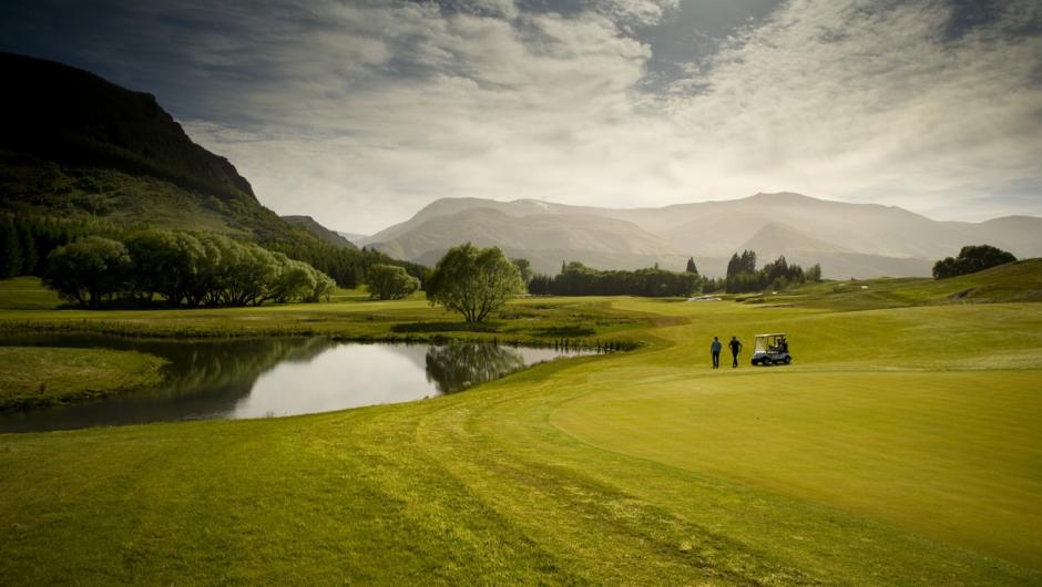 Golfers walk up Millbrook Golf Course &#039;Coronet Nine&#039; Course, South Island, New Zealand