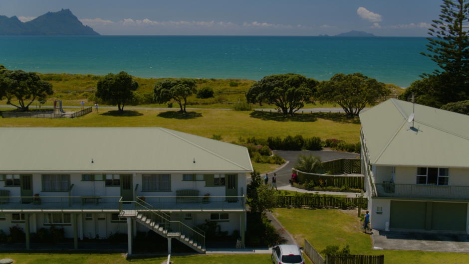 View from behind the motel towards the Bream Bay coastline. Pictured is the downstairs access studio to the right with private parking right outside.