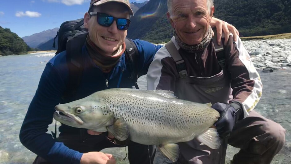 Father son duo catching a wonderful brown trout, South Island New Zealand.