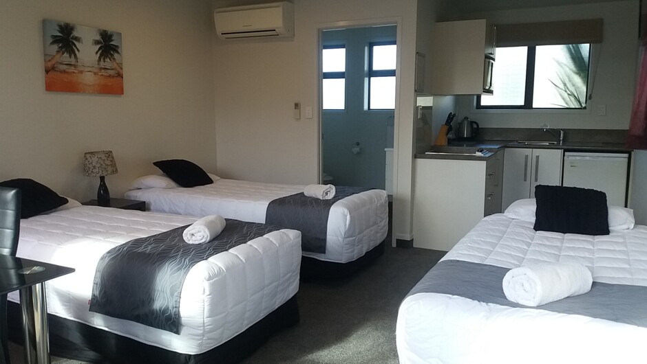Motel style studio with 3 single beds, bathroom , kitchen and sky tv. air con /heat pump.  overlooking pool area