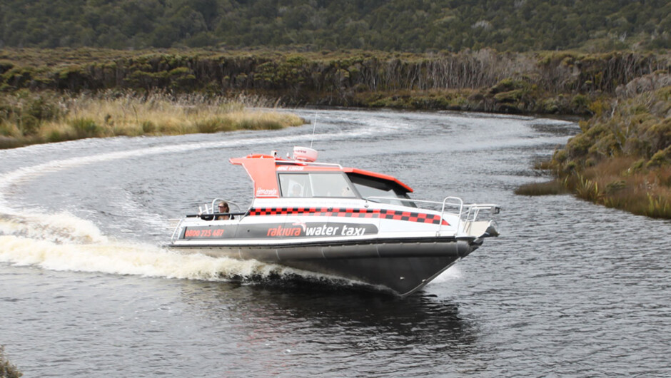 Our purpose-built vessel, Henerata, navigating the river