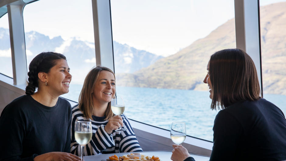Enjoying a Gibbston Valley cheese board and glass of Akarua wine on the lake cruise