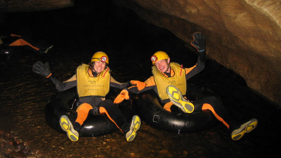 On your tubes and ready to raft through the Glowworm Caves in the Metro Cave near Charleston on the West Coast.