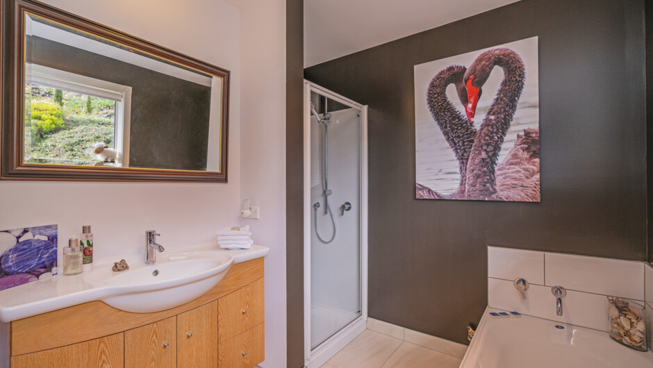 The Tui Suite Bathroom with bath and walk-in shower, vanity and toilet