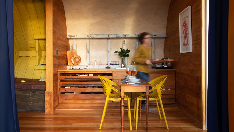 The kitchen was built with recycled architectural plan drawers and salvaged Kauri from the boat. You can open all the doors to be sitting at one with the river - wonderful in the early morning.