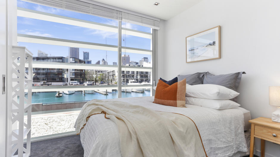 Wake up to gorgeous water views in the master bedroom.