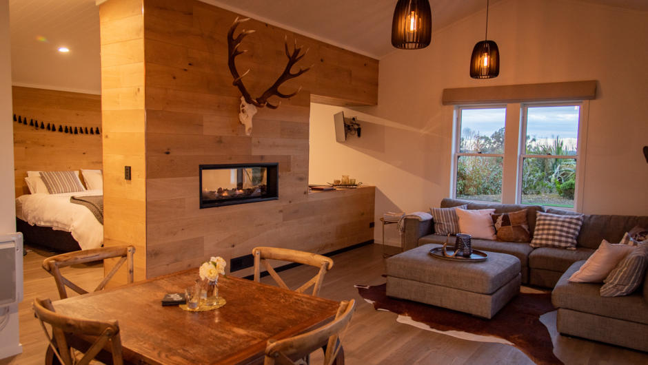 A luxury bedroom and ensuite has views through the double sided fireplace up to Mt Somers.