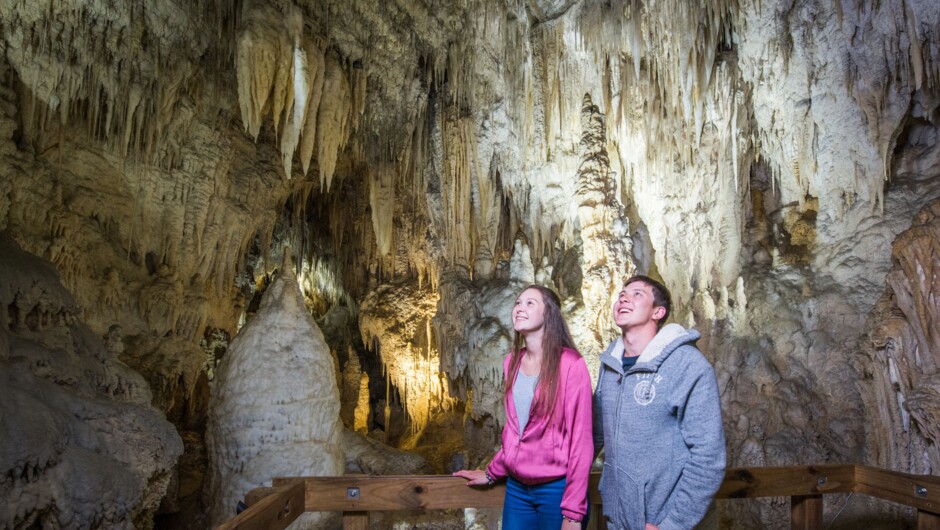 A couple admiring the stalactites and other cave formations in Aranui Cave.