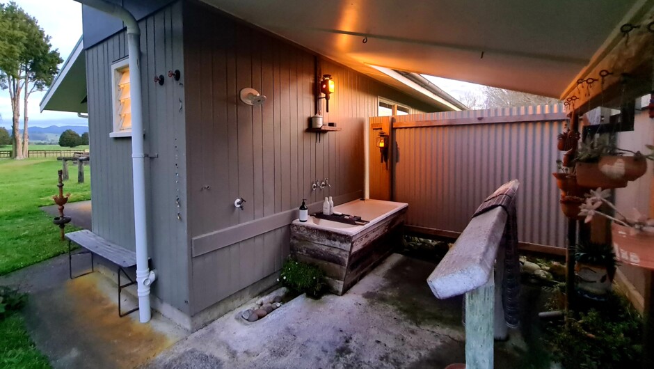 Outdoor bathroom with shower and deep tub, relax and unwind.