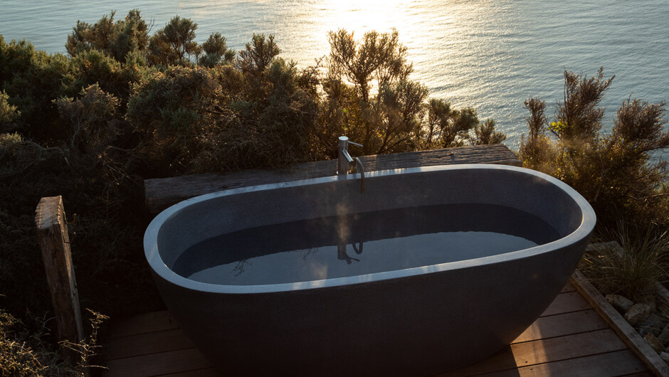 Watch the sun disappear behind the South Island from the outdoor hot tub nestled within the native bush, 250 metres above sea level.