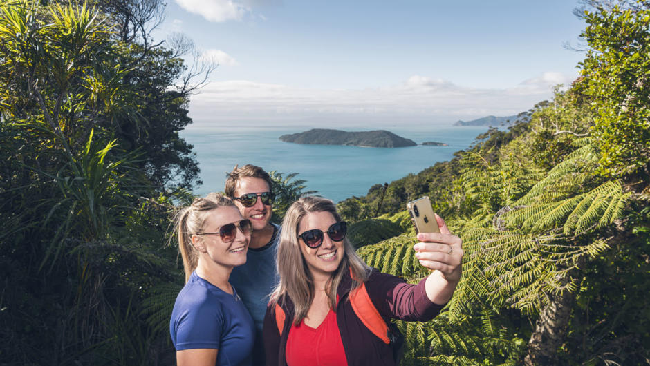 Friends taking selfie at Queen Charlotte Track lookout.