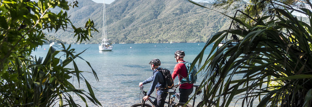 Bikers admiring the scenic water views along the Queen Charlotte Track