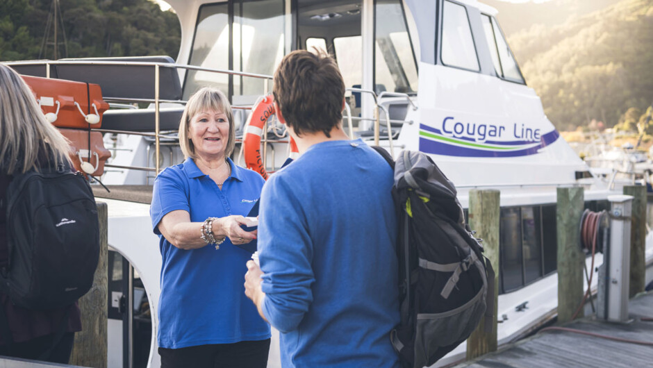 Cougar Line staff welcoming passengers on board boat at Picton