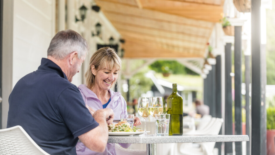 Couple enjoying lunch on Furneaux Lodge verandah