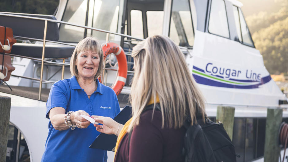 Cougar Line staff welcoming passengers on board boat