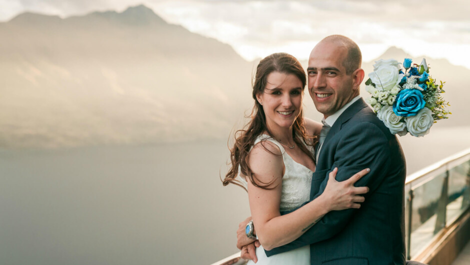 A newly married couple poses for a photo on the Skyline Queenstown viewing platform.