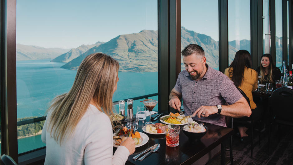 A couple enjoys dinner at the Stratosfare Restaurant with incredible views.
