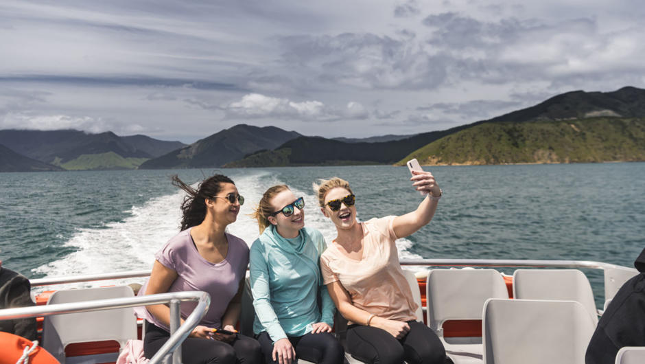 Group of friends taking selfie onboard the Pelorus Express