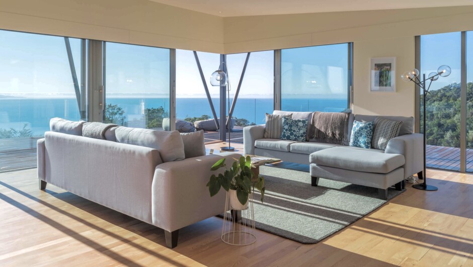 The open living room with cosy loungers to enjoy your beautiful surroundings