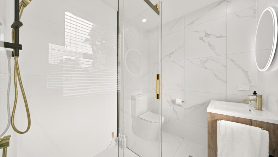 The beautifully floor to ceiling tiled bathroom includes a full size shower, vanity fitted with the very best Italian brass tap wear, hotel quality bath towels, plus all your amenities - body wash, shampoo and conditioner.