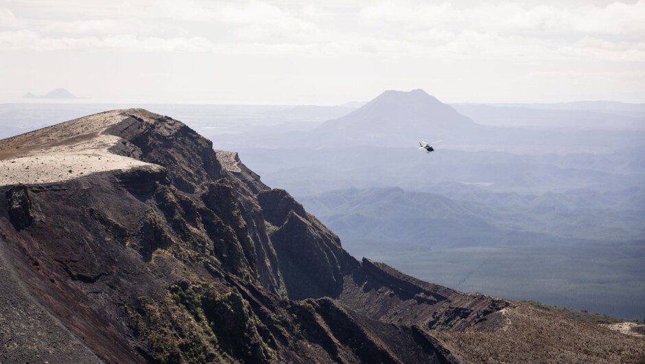 Helicopter approaching Mount Tarawera with Mount Edgecumbe in the background