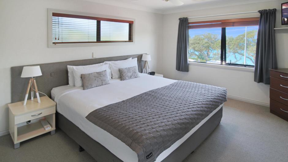 Executive 1 bedroom suite master bedroom with ocean views, and super king bed with crisp white linen