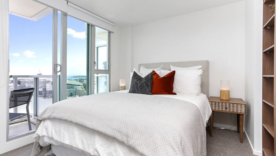 Second bedroom with gorgeous natural light and access to balcony. This bedroom also has ample storage space.