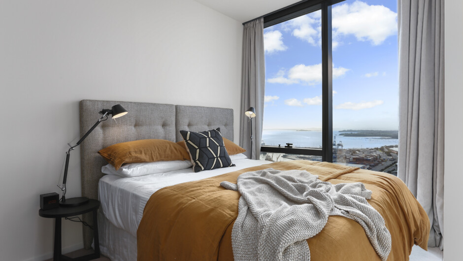 The second bedroom has floor to ceiling windows providing uninterrupted views from your exquisite bed.