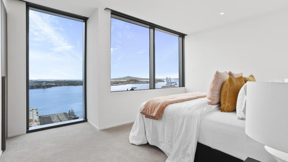 Luxuriously spacious master bedroom featuring the stunning harbour view.