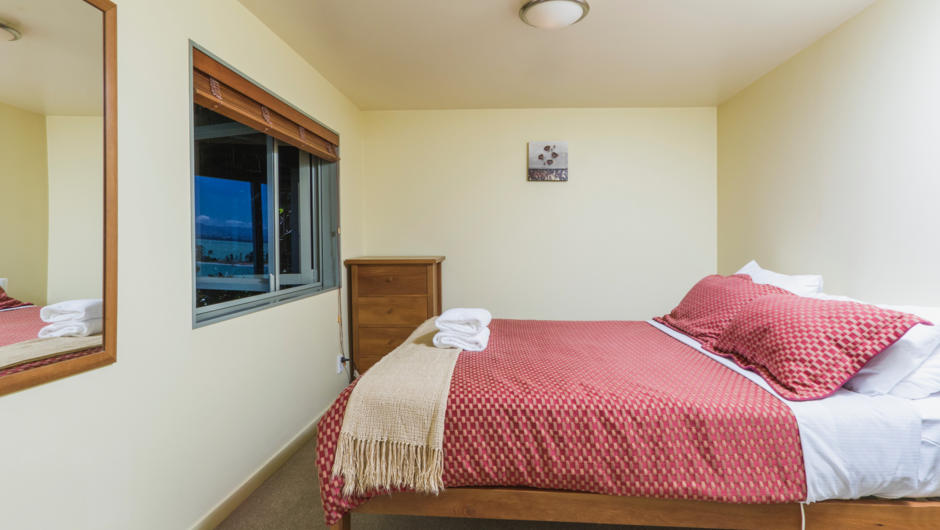 Bedroom with queen bed &amp; views over Tasman Bay &amp; the Harbour entrance