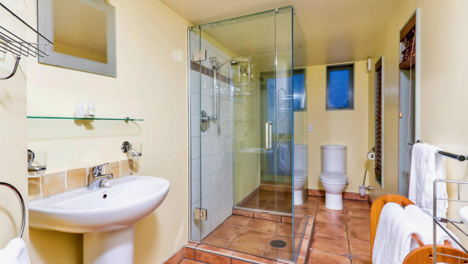 Well appointed tiled bathroom with shower, vanity & toilet