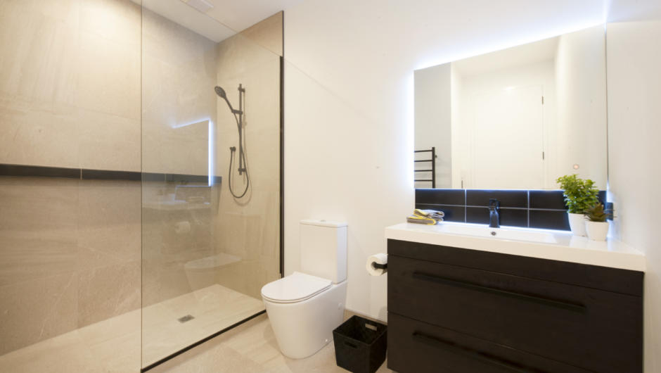 Master bedroom ensuite with walk in tile shower, toilet &amp; vanity