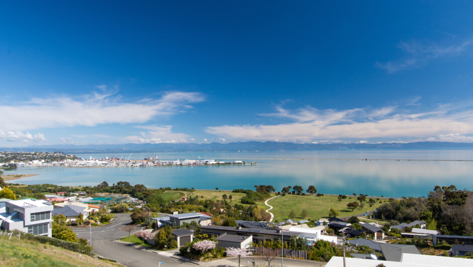 Behold your spectacular view! Miyazu Gardens below, the Haven Estuary, Boulder Bank, Port Nelson, Tasman Bay.