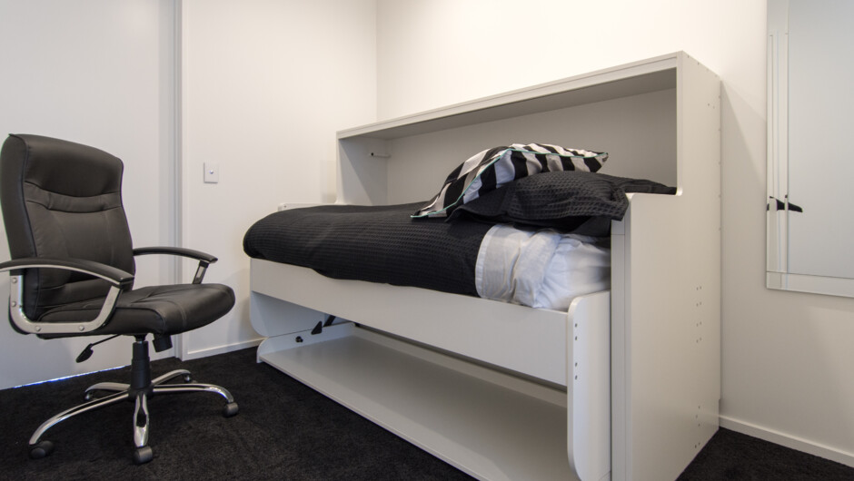 Single bed in adjacent study area (this is stowaway bed that easily converts from desk to bed).