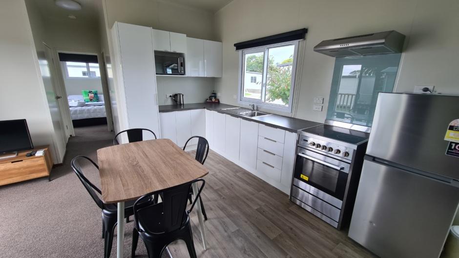 Our Premium 2 bedroom units are the perfect home away from home.  Featuring a big lounge area in the middle, a full size kitchen with full size appliances, TV,  table and chairs, heatpump, bathroom, washing machine and 2 separate bedrooms with large wardr