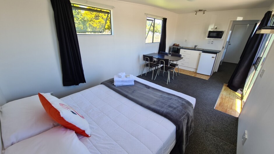 Our Self-contained units have all that one will need for wee holiday.  Featuring a bed in the lounge, TV and table and chairs plus small kitchenette, a spare bed in the bedroom, and a bathroom.