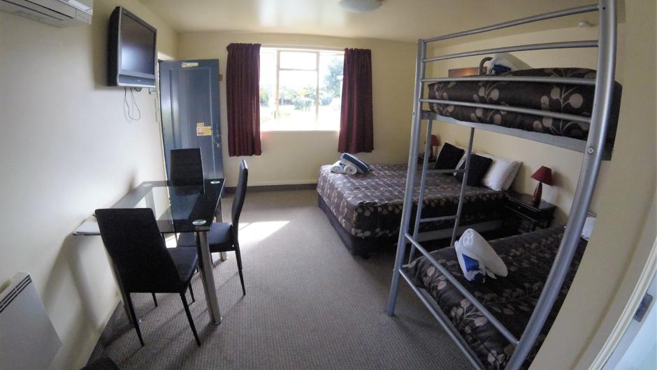 Studio unit sleeps 4, queen bed and set of bunks in living area.  Fully self contained with Bathroom and kitchen and sky tv, carport