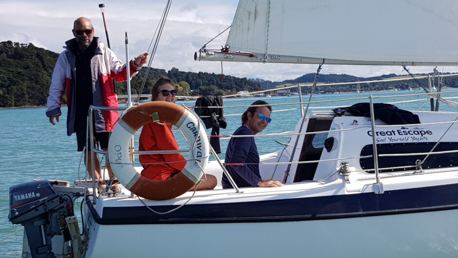 Instructor on the stern, sailors having fun aboard a Davidson 20