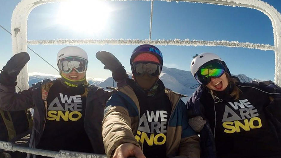 WE ARE SNO instructors taking a lift selfie.