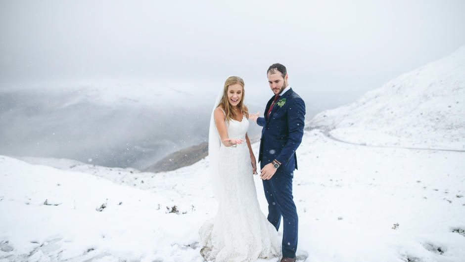 Wedding couple in an autumn snowfall near Queenstown.