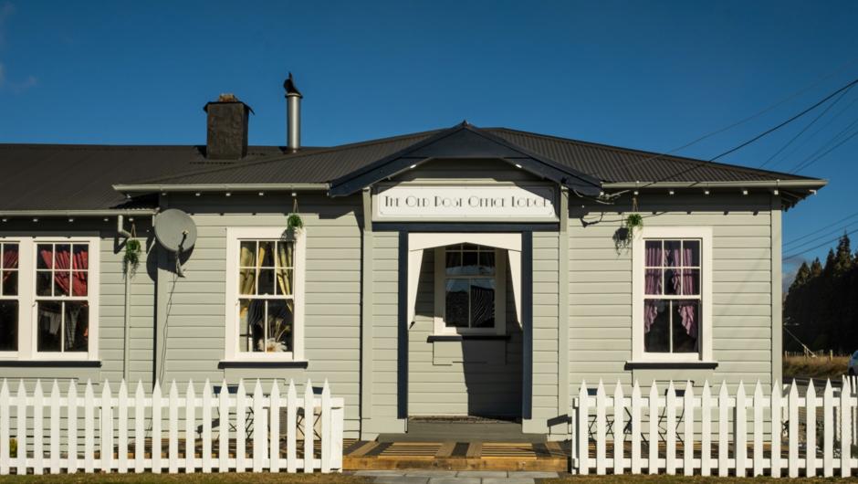 Owhango&#039;s iconic century-old Post Office, transformed into an opulent art-deco boutique lodge.