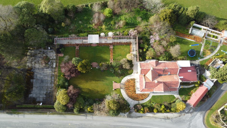 An aerial view of the property showing the extensive landscaped gardens and pergola that the property is famous for.