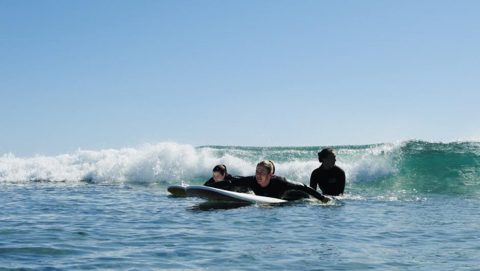 Women learning to surf.